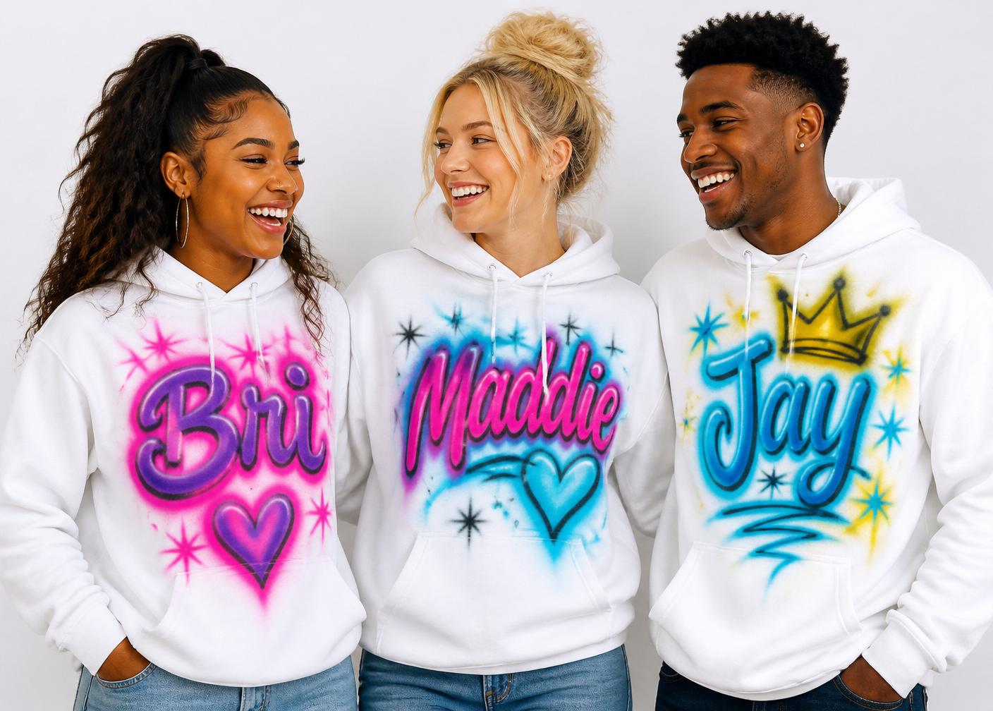 Three friends wearing custom airbrushed hoodies with their names
